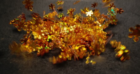 Small colorful particles shaking against dark background