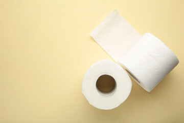 Roll of toilet paper on beige background. Space for text