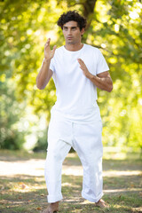 a young man doing yoga at green city park