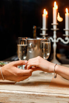 Date In A Restaurant. Hands Of A Man And A Woman At A Romantic Candlelight Dinner