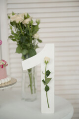 A wooden figure is one, with a flower, a decorative element of a birthday.
