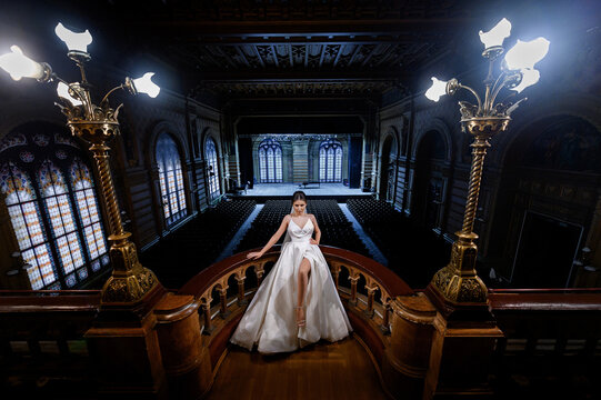 Bride statning on balcony with scene of theatre background