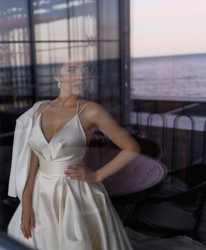 Reflection of girl in wedding dress in window
