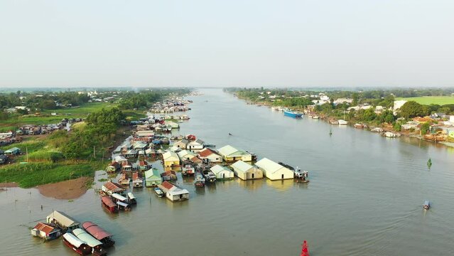 The floating village of Chau Doc on the Bassac River in Asia, Vietnam, in the Mekong Delta towards Ho Chi Minh city in summer on a sunny day.