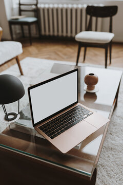 Laptop computer with blank screen on table. Aesthetic influencer styled workspace interior design template with mockup copy space