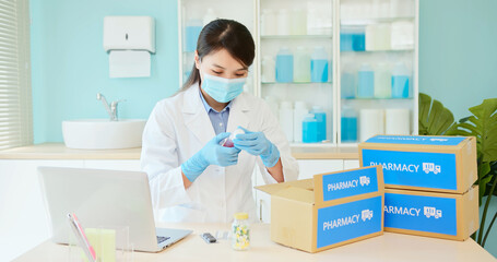 asian pharmacist pack medication