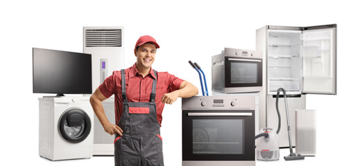 Repairman in a uniform standing next to an electric oven and other appliances