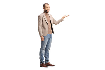 Full length shot of a young man with a headset presenting with hand