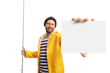 Smiling fisherman holding a fishing rod and showing a blank card