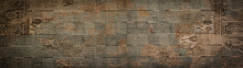 Old brown gray rusty vintage worn shabby patchwork square motif tiles stone concrete cement wall...