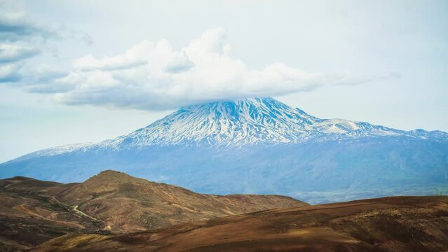 Static dynamic timelapse of snowy mountain ararat peak with cloud pass from Turkey side in late spring. At the foot of mt Ararat
