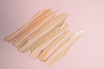 BB, CC cream foundation tonal smudge. Foundation swatch on pastel pink background