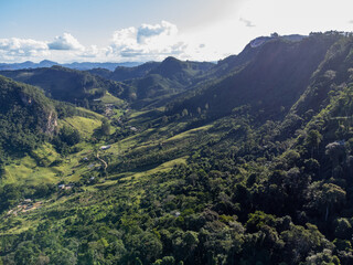 Naklejka premium beautiful green valley with coffee, eucalyptus and banana plantation, drone aerial view - Venda Nova, Espirito Santo, Brazil