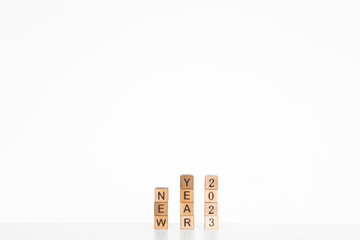 letters of the alphabet of New Year 2023 on wooden cubes, white background