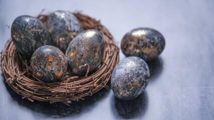 Easter card with a copy of the place for the text. Very Peri 2022 .Purple, blue eggs in a basket on a dark newspaper background. Natural dye karkade tea.