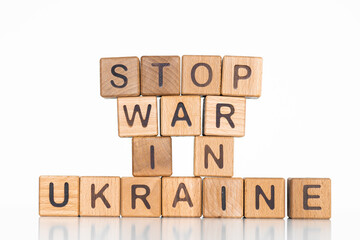 Stop war in Ukraine words written on wood block. Text on table, concept.