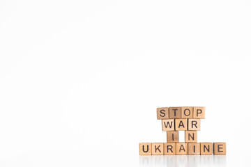 Stop war in Ukraine words written on wood block. Text on table, concept.