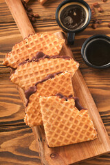 Coffee and dutch waffles. Espresso coffee and dutch waffles or syrupwaffles cookies with chocolate on old wooden table. Perfect syrupwaffles cookies for Breakfast. Top view. Mock up.