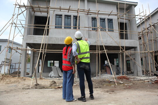 Diverse Team of Specialists engineering on Construction Site. Real Estate Building Project with Civil Engineer, Architect, Business Investor and General Worker Discussing Plan Details.