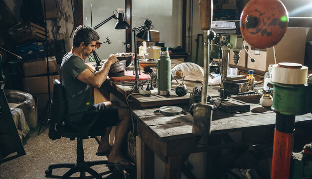 Mature silversmith working in workshop