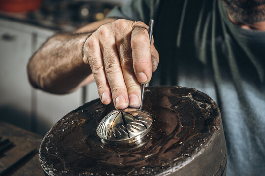 Anonymous silversmith punching ornament on silver lid