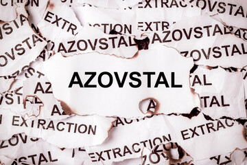 Scraps with the inscription Azovstal and extraction on torn burnt paper