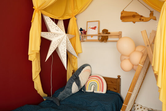 Cozy child bedroom interior decorated with canopy