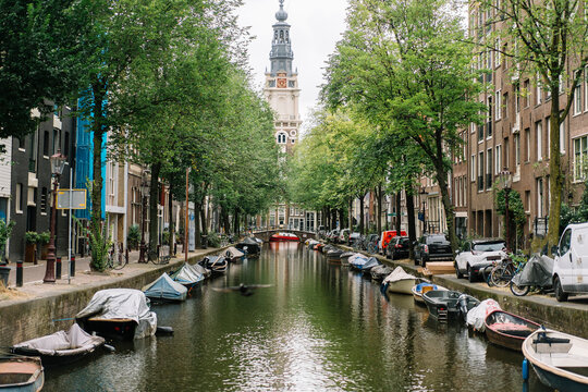 Scenic cityscape with old Protestant church and boats on canal