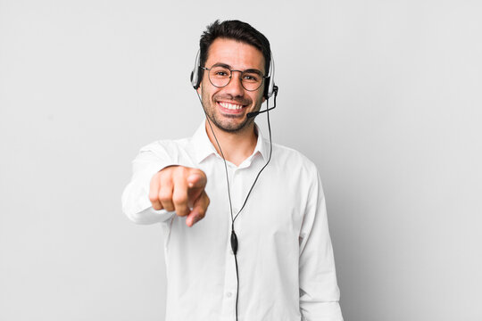 young adult hispanic man pointing at camera choosing you. telemarketer concept