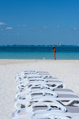 Funny moment of an attractive young woman and her dog at Isla Mujeres beach in Mexico