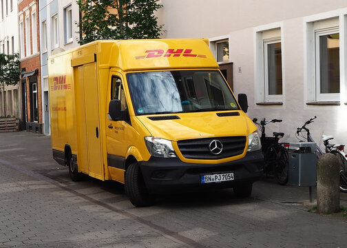 A DHL parcel delivery van in a German high street 