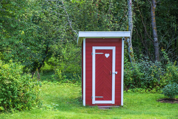 Outhouse with a heart on the door in a garden