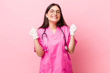 young pretty woman feeling shocked,laughing and celebrating success. veterinarian concept