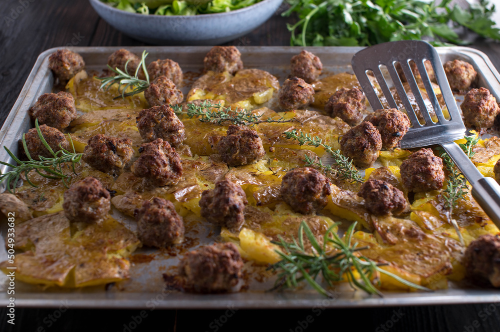 Wall mural Family meal with oven baked meatballs and smashed potatoes