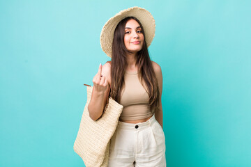 young pretty woman feeling angry, annoyed, rebellious and aggressive. summer and hat concept