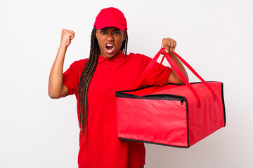 young adult black woman shouting aggressively with an angry expression. pizza delivery concept
