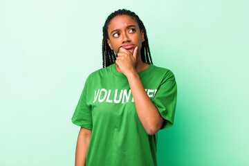 young adult black woman thinking, feeling doubtful and confused
