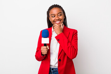 young adult black woman smiling with a happy, confident expression with hand on chin. presenter and...
