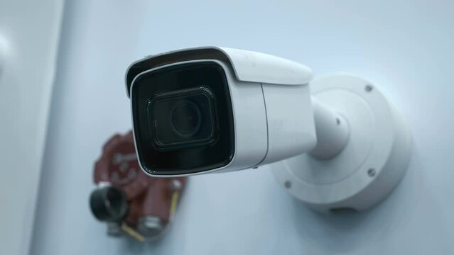 The CCTV camera perform security functions on the territory of the protected object and check the surrounding area looking for the criminal. Closeup. Shot in motion