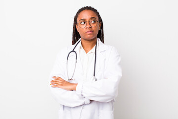 young adult black woman shrugging, feeling confused and uncertain. physician concept