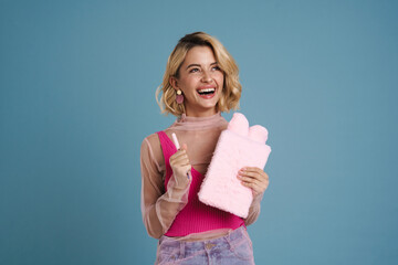 Young woman laughing while posing with stuffed exercise book