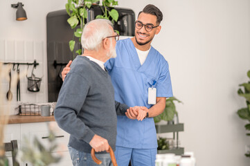 Nurse assisting a patient to walk with a walking stick