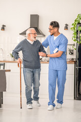 Patient moving around the kitchen assisted by his in-home nurse