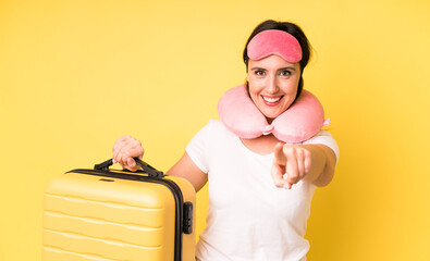 young adult pretty woman pointing at camera choosing you. flight passenger concept