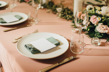 Wedding table setting with place cards in light peach color. Romantic wedding in a villa on Lake Como
