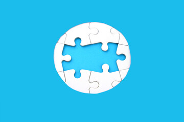 Frame of white puzzles on blue background. Place for your text. Mock up