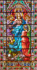 VALENCIA, SPAIN - FEBRUAR 17, 2022: The Assumption in neo-gothic stained glass of  church Basilica de San Vicente Ferrer by Talleres Maumejean Hermanos from 20. cent. - obrazy, fototapety, plakaty