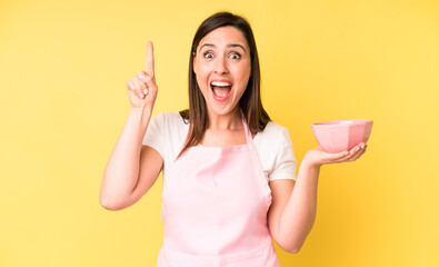 young adult pretty woman feeling like a happy and excited genius after realizing an idea. cooking...
