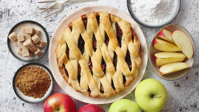 Fresh baked tasty homemade apple pie cake with ingredients on side