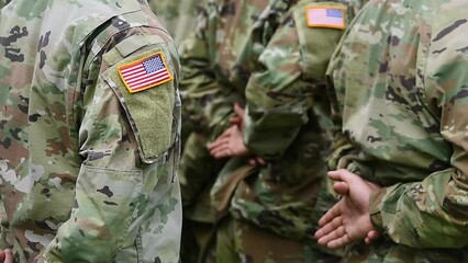 Detail clip with american flag on soldier uniform standing in military position during ceremony